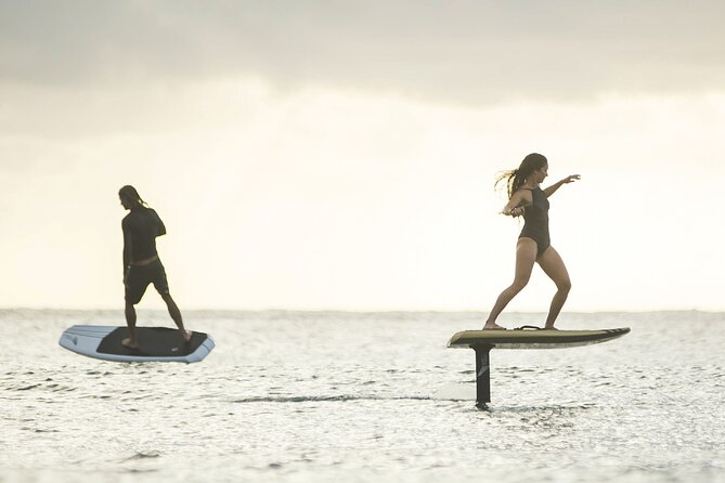 Person riding a Fliteboard eFoil at sunset in Ibiza
